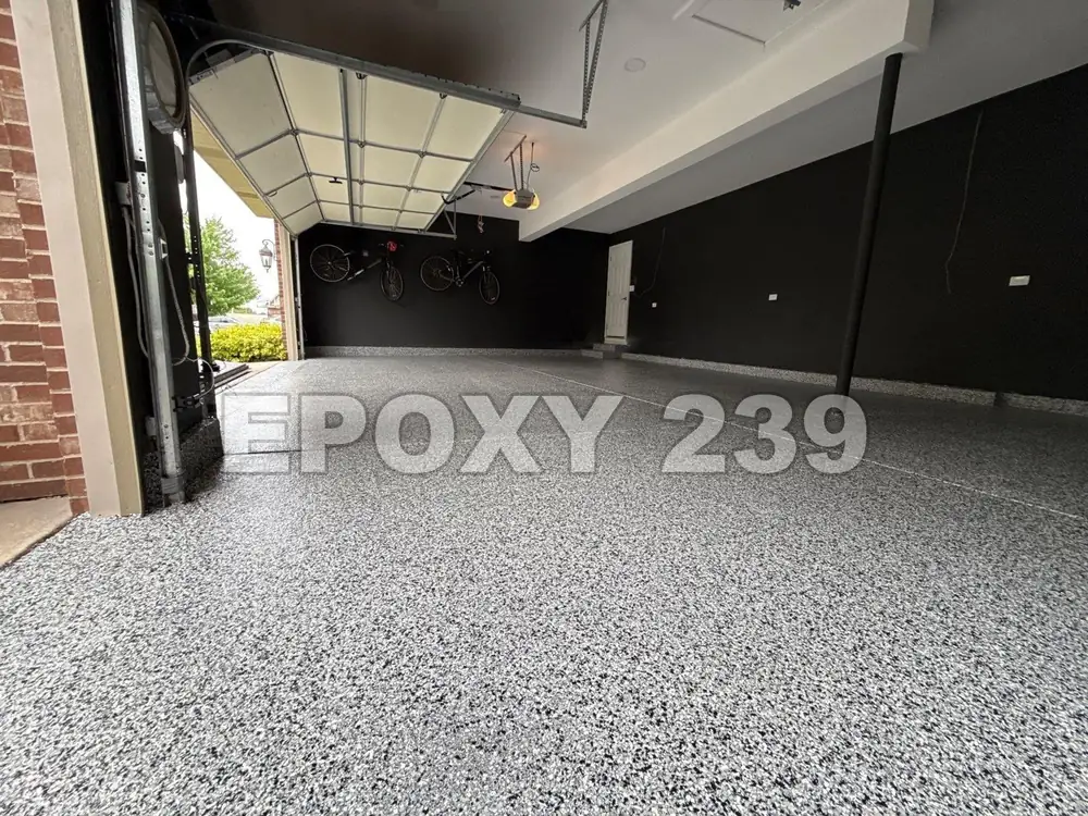 Garage with black walls and a light Domino flake epoxy floor