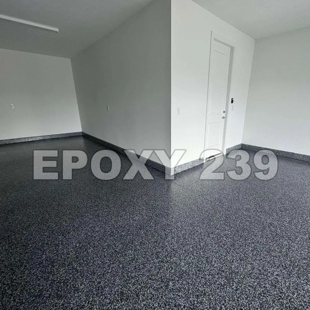 Room with white walls and a dark, glossy Glacier flake epoxy floor