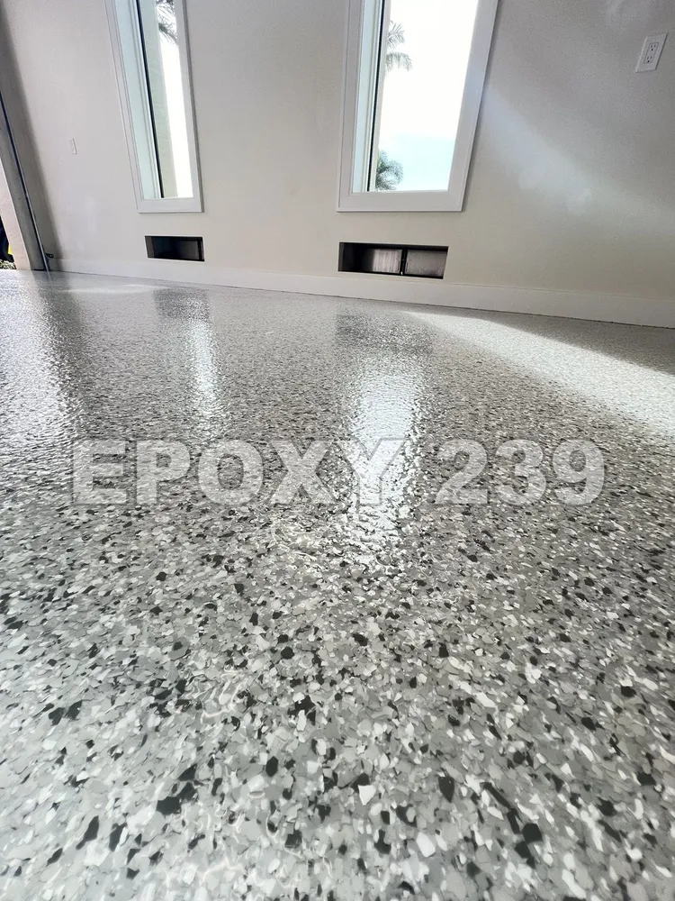Close-up of a glossy grey flake epoxy floor in a sunlit room