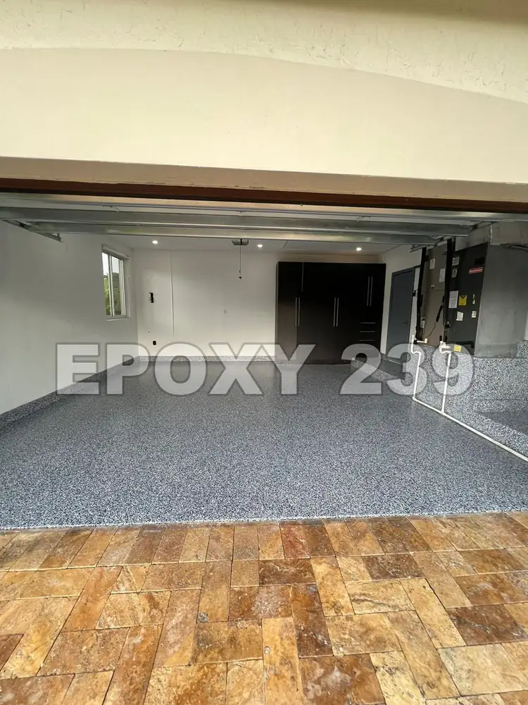 Garage opening onto a lounge, with an Orbit flake epoxy floor