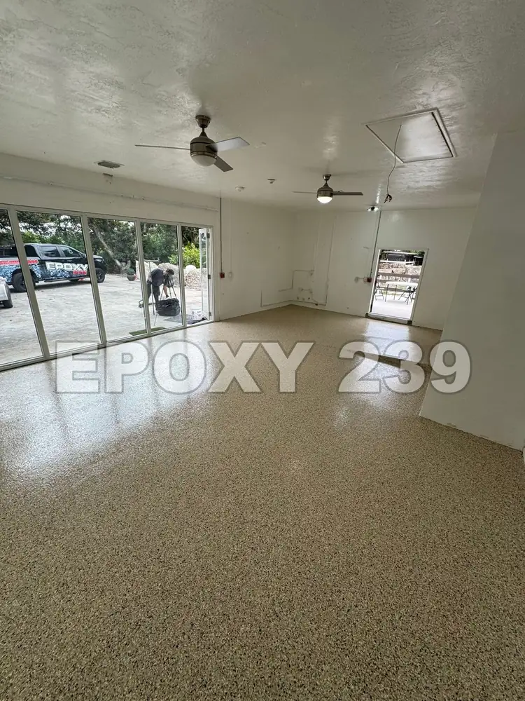 Great room with sliding doors and a glossy Shoreline flake epoxy floor