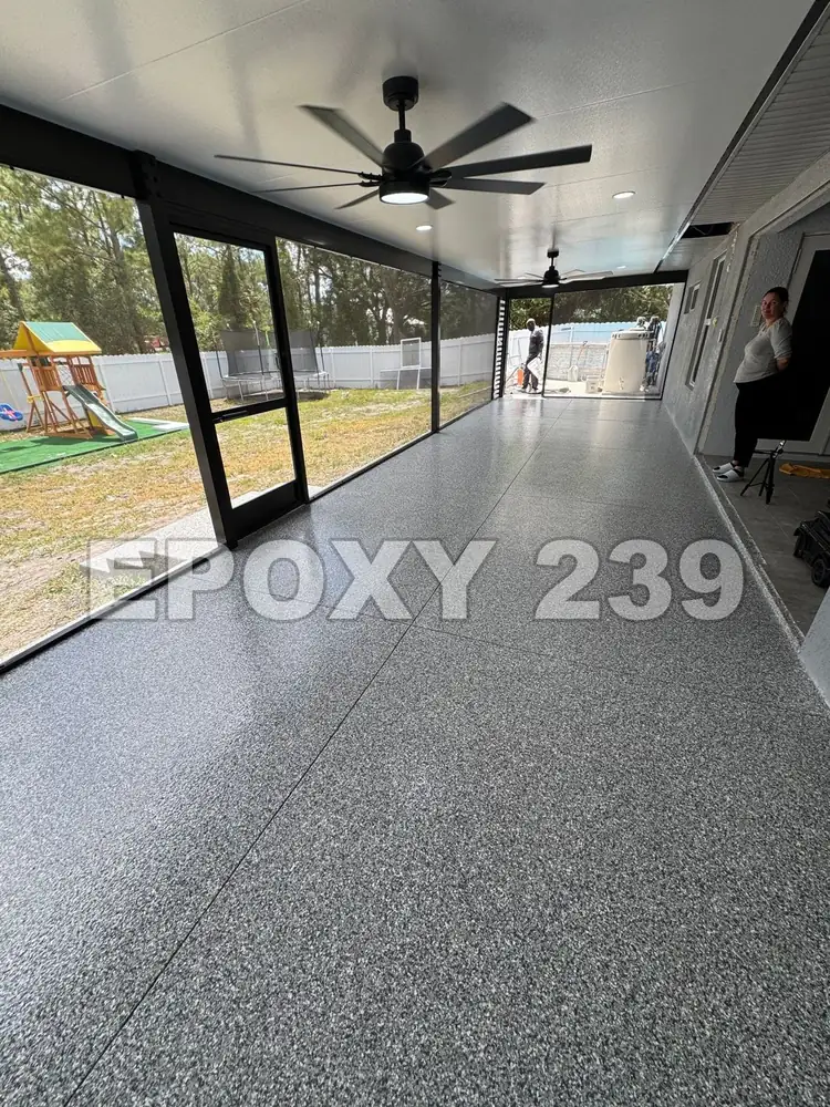 Screened lanai with a ceiling fan and a grey Gravel flake epoxy floor