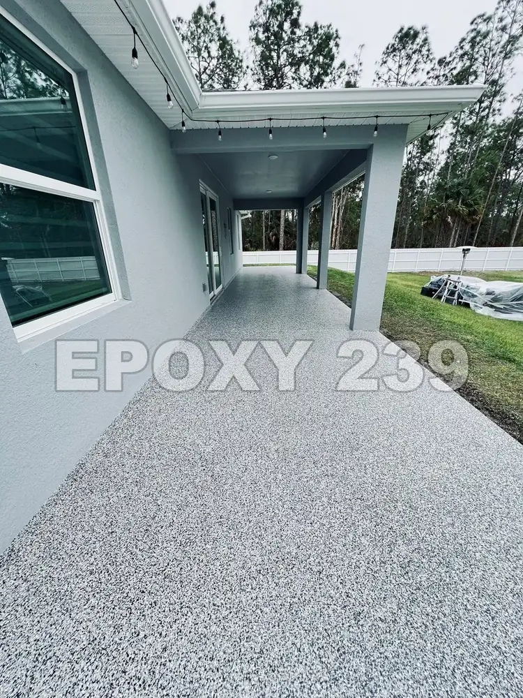 Long covered lanai beside the house with a Domino flake epoxy floor